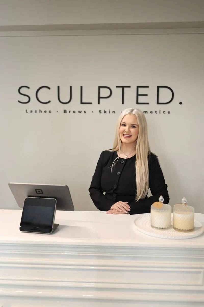 Chelsie at the Sculpted front desk